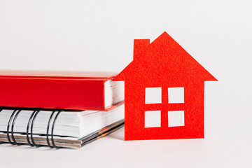 Sweet home. Estimating and paying house tax. Mock up with red house, notepad and sticker in copy space white background