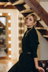 beautiful blonde in a black outfit with gold accessories. Soft selective focus, defocus, art noise