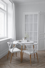 White loft interior in a Scandinavian style with a table. Set wooden table in a bright interior, photo studio.
