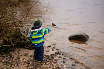 toddler walking on the riverbank, selective focus