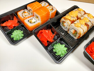 Assorted sushi rolls on an isolated white background. Delivery of Japanese cuisine.