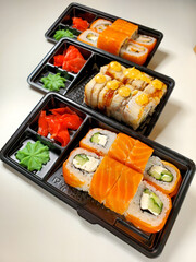 Contactless food delivery under quarantine from coronavirus. Delivery of food and sushi rolls.