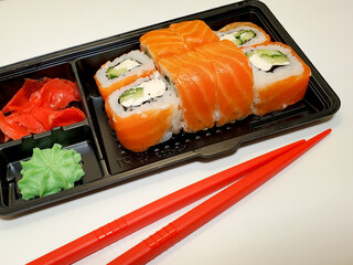 food Supplies. Sushi and rolls with salmon and shrimp. The concept of food delivery on self-isolation.