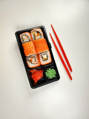 close-up of Japanese sushi rolls for dinner or lunch on an isolated white background. The concept of delivery of Japanese cuisine.
