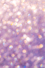 bright glitter background: bokeh effect from many colored lights on frozen glass, toning