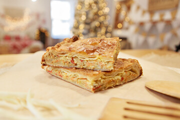 Chicken and potato pie on the dining table. The food is ready to eat. Puff pastry. kitchen utensils for cooking