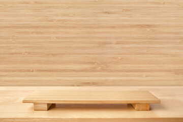 Empty sushi board on wood table with bamboo background. Top view of plank wood for graphic stand product, interior design or montage display your product.