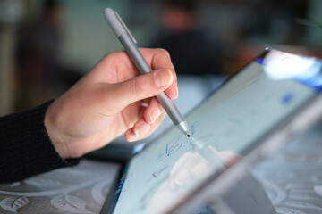 Left woman had while using graphics tablet stylus for home smart working,digital technology