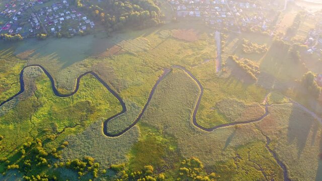 4K aerial - a bird's eye view&nbsp;video (Ultra High Definition). Colorful summer view of flooded valley. Misty morning scene of snake shape Seret river. Sunrise on Ternopil countryside, Ukraine, Europe. .
