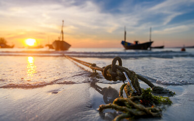 The anchor of  fishery boats in the sunset time.