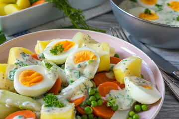 Egg dish with vegetables, sauce and potatoes