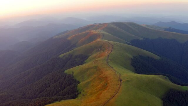 4k drone flight moving to the side and back footage (Ultra High Definition) of Menchul mountain range. Colorful evening view from flying drone of Carpathian mountains. Sunset in mountains.