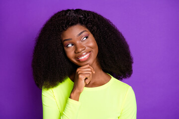 Fototapeta na wymiar Photo of young happy positive dreamy smiling afro girl look copyspace thinking isolated on purple color background
