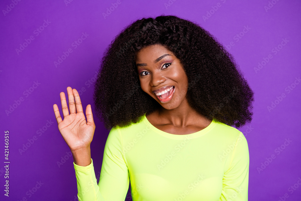 Sticker Photo of young attractive smiling excited positive african girl showing hand say hello isolated on violet color background