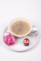 A cap of coffee with flower and sweet