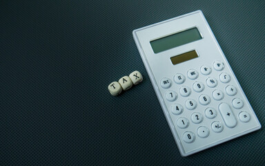 The wood text and calculator on black background for business content