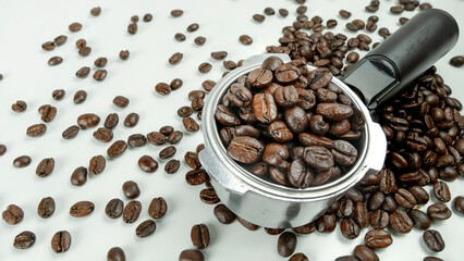 White background Portafilter with Arabica coffee beans, Perfect for a barista in a coffee shop. Used to make espresso. Coffee is a very popular international drink.