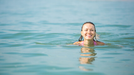Fototapeta na wymiar summer vacation woman , swimming in blue sea