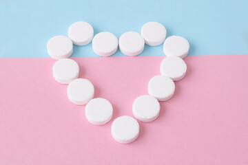 a heart made of white round pills. The concept of health and medical care