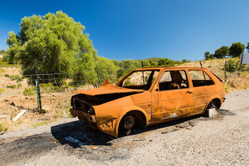 Abandoned old rusty wreck of a car