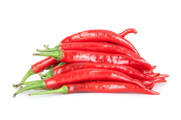 A pile of red peppers on a white background