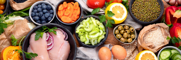 Selection of organic raw healthy products on gray background product.