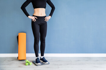 woman in black sport clothes standing on scales