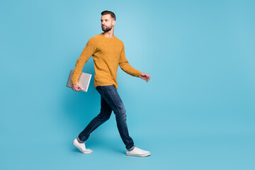 Fototapeta na wymiar Full length body size view of attractive guy employer going office carrying laptop isolated over bright blue color background