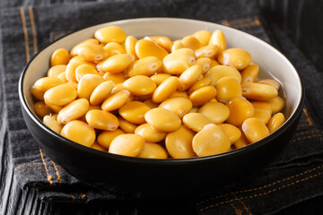 Diet appetizer pickled lupine beans close-up in a bowl on the table. horizontal