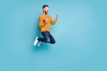 Fototapeta na wymiar Full length body size view of nice overjoyed cheerful guy jumping having fun rejoicing isolated on bright blue color background