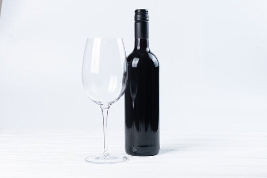 Black bottle of wine and glasses isolated on white