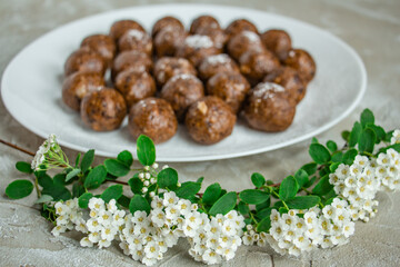 truffles with cocoa, coconut, sesame seeds with chocolate and marshmallows, delicious dessert on a concrete background