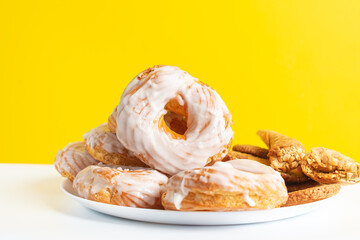 Sweet chocolate donut on yellow background. Dessert food