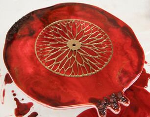 craft, pomegranate clocks with epoxy resin in a bright room, on a white table, in the afternoon. Master class, hobby, rest, new hobbies, creative profession. Epoxy painting