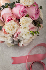 Delicate wedding bouquet of white and pink roses
