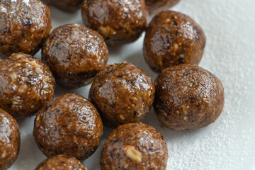 truffles with cocoa, coconut and sesame seeds with chocolate and marshmallows, delicious dessert on a white background