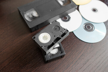 videotape and cd on brown wooden background