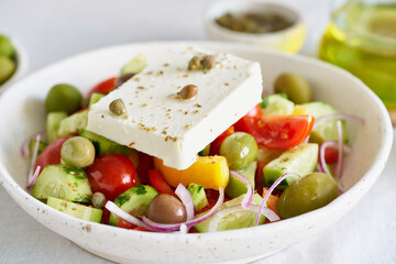 Greek village salad horiatiki with feta cheese and vegetables, vegeterian mediterranean food, low calories keto dieting meal, side view, close up