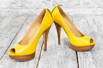 Pair of woman shoes on a wooden floor. High heels, shopping and sale theme.