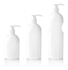 White bottles with shampoo with dispenser on white background