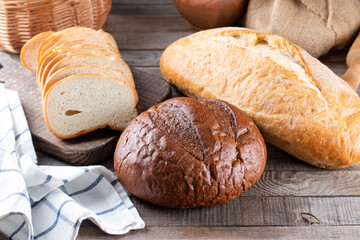 Assortment of baked bread on wooden table