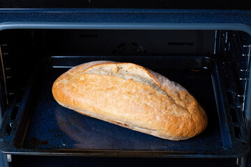 Frozen bread in the oven. Defrosting bread
