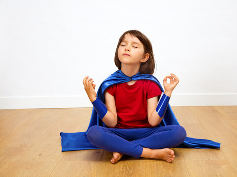 relaxed superhero child meditating with yoga, mindfulness, meditation, bare feet