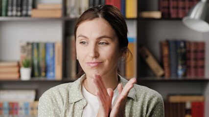 Woman sarcastic applause. Gloomy skeptical woman in office or apartment room reluctantly claps her...
