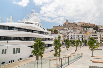 Fototapeta premium Ibiza old town and a huge yacht in the marina