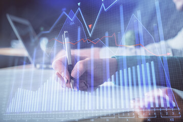 Double exposure of forex chart drawing over people taking notes background. Concept of financial analysis