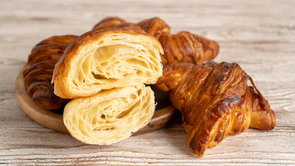 Homemade golden croissants on white wooden table. Perfect classic French croissants. Top view 