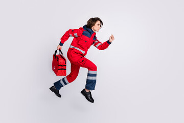 Fototapeta na wymiar Full size profile side photo of serious woman paramedic running first aid help isolated on grey color background