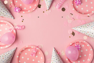 Top view photo of birthday composition with pink ribbon stars serpentine hats paper plates balloons and confetti on isolated pastel pink background with copyspace