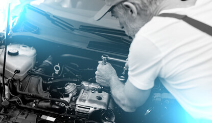 Fototapeta na wymiar Car mechanic working on car engine; light effect